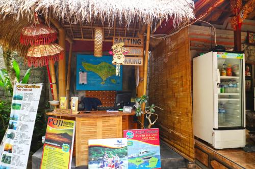 a restaurant with a counter and a refrigerator at New Ubud Hostel in Ubud
