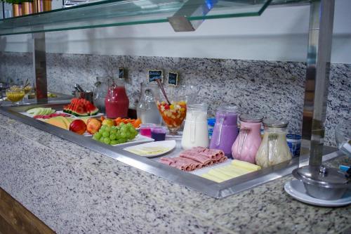 a buffet with meat and vegetables and other food items at Oriental Praia Hotel in João Pessoa
