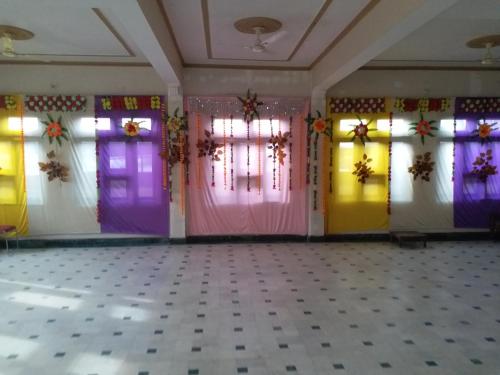 a room with brightly colored doors and windows at Hotel Narayan Palace in Amarsar