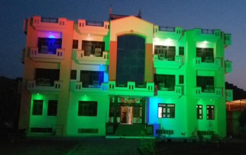 a building with colorful lights on it at night at Hotel Narayan Palace in Amarsar