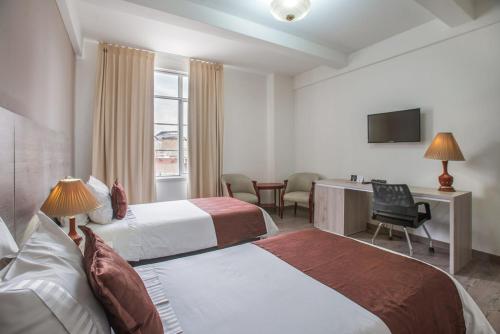 Säng eller sängar i ett rum på Hotel Nutibara