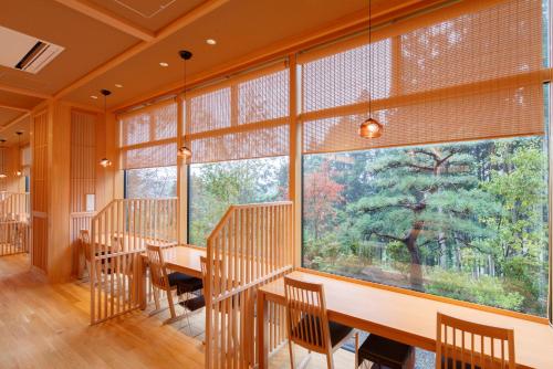 a large room with a table and chairs and a large window at Hotel Mori no Kaze Nasu in Nasu