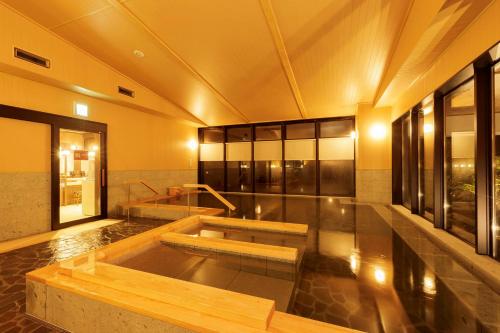 a large room with a hot tub in a building at Hotel Mori no Kaze Nasu in Nasu