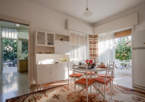a kitchen with a table and chairs in a room at Sunny Family Home By The Beach in Limassol