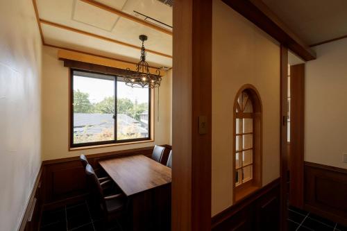 a dining room with a table and a window at Hotel Shiki no Yakata Nasu in Nasu