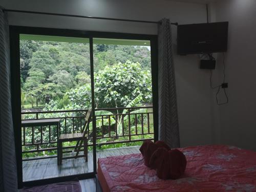 a bedroom with a window with a view of a balcony at Yuyu Golden Beach in Ko Chang