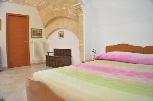 a bedroom with a large bed and a fireplace at Borgo Saraceno in Spinazzola
