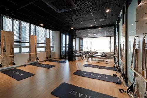a gym with yoga mats on the floor at Hotel NewV in Seoul