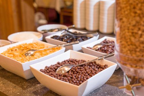 a table topped with bowls of nuts and spoons at Hotel Kroneck in Kirchberg in Tirol