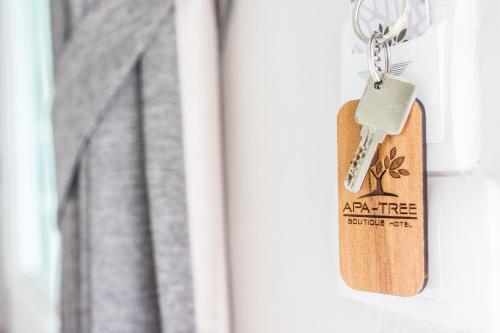 a keychain hanging from a door with a price tag at APA-TREE Boutique Hotel in Natai Beach