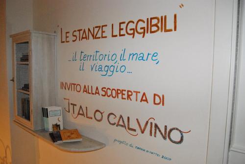 a wall with writing on it in a bathroom at Hotel Vita Serena in Arma di Taggia