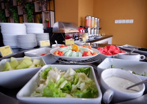 a buffet with bowls of food on a table at MaxOne Platinum Hayam Wuruk in Jakarta
