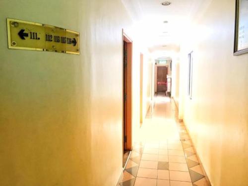 a hallway of a building with a sign on the wall at Hotel Sri Raub in Raub