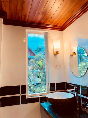 a bathroom with a sink and a window at Merry Riverside Hotel in Luang Prabang