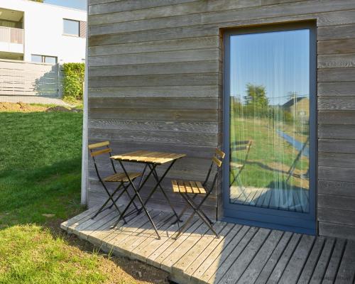 a table and two chairs on a wooden deck at La Huche in Namur
