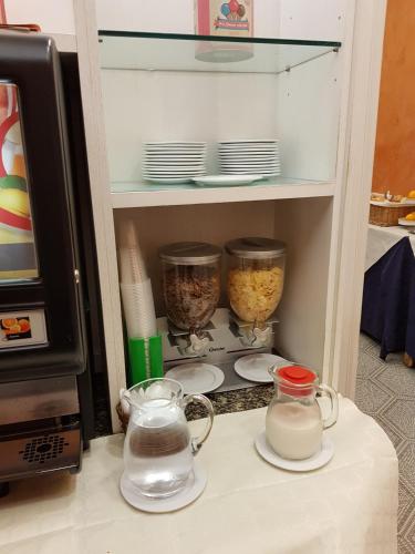a cupboard with bowls and dishes on a counter at Hotel Kennedy in Rome