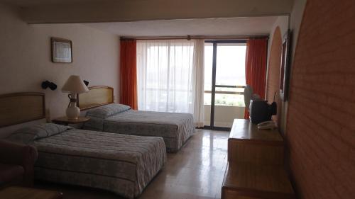 Postel nebo postele na pokoji v ubytování Hotel Piedras de Sol Solaris Morelos