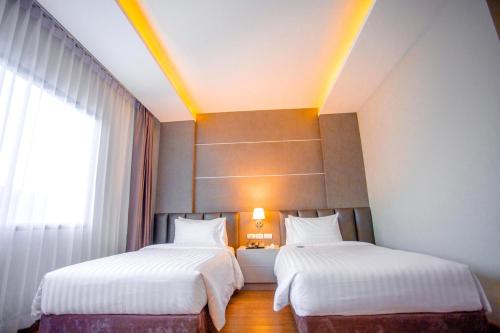Postel nebo postele na pokoji v ubytování The Cheewin Hotel And Convention