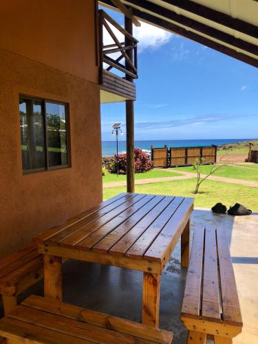 a wooden picnic table on the porch of a house at Cabañas Anavai Rapa Nui in Hanga Roa
