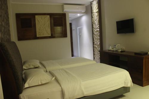 מיטה או מיטות בחדר ב-Onih Hotel