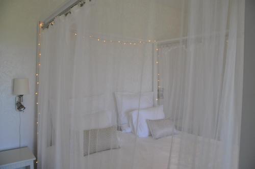 a white room with a white curtain and lights at Hotel Bella Luna in Båstad