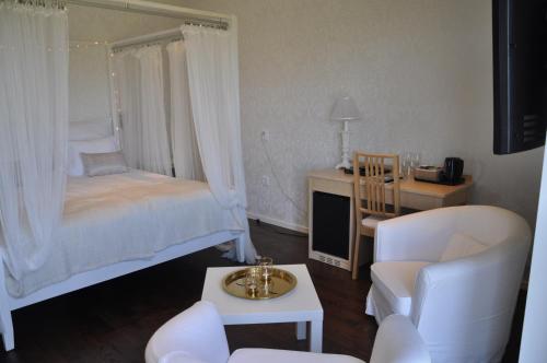 a bedroom with a bed and a desk with a chair at Hotel Bella Luna in Båstad