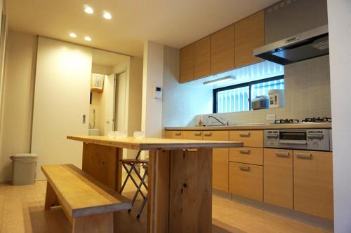 a kitchen with a wooden island in a room at Ichijo Premium in Kyoto