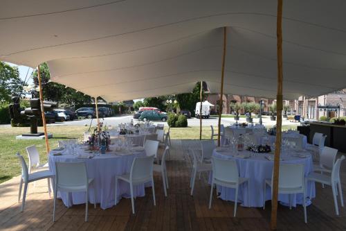 a group of tables and chairs under a tent at Hotel De Pupiter in Kluisbergen