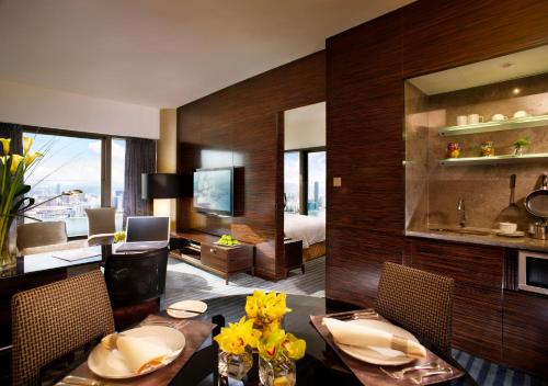 a kitchen with a table, chairs, and a table cloth at Harbour Grand Hong Kong in Hong Kong