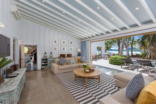 a living room with a couch and a table at Kalim Beach House - Private Beach & Pool in Patong Beach