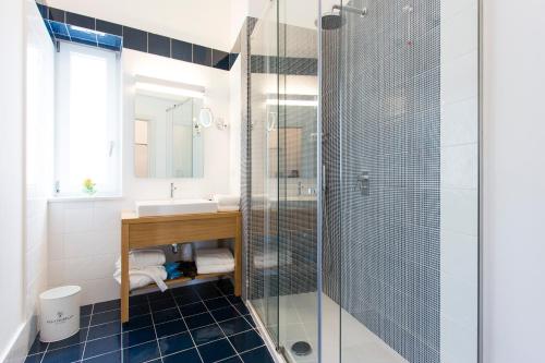 a bathroom with a glass shower and a sink at Villa Fiorella Art Hotel in Massa Lubrense