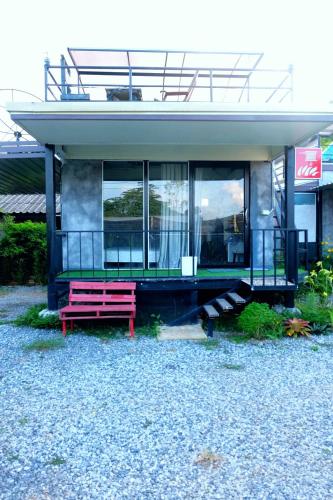 a red bench sitting in front of a building at Sida Homemade in Chiang Khan