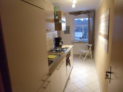 a kitchen with a sink and a stove top oven at Ferienwohnung Simone in Radebeul
