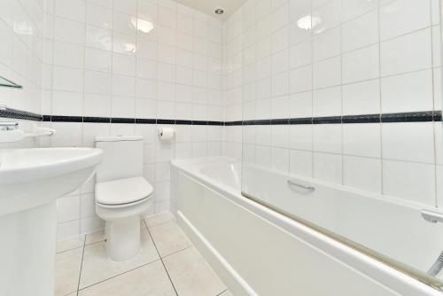 a white bathroom with a toilet and a sink at Euro Hotel in London