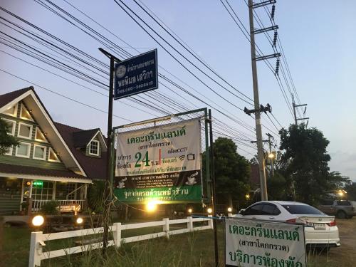 a couple of signs in front of a house at The Green land (Khok Kruat) in Nakhon Ratchasima