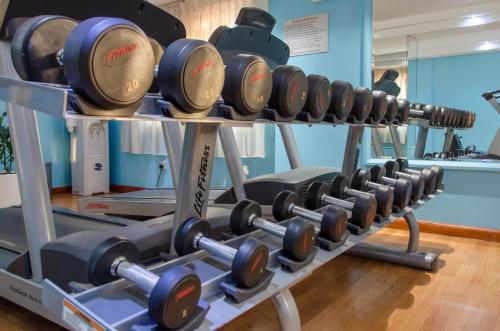 a row of dumbbells in a gym at Avenue Hotel Dubai in Dubai