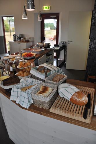 a table with many different types of bread on it at Hotel Bella Luna in Båstad