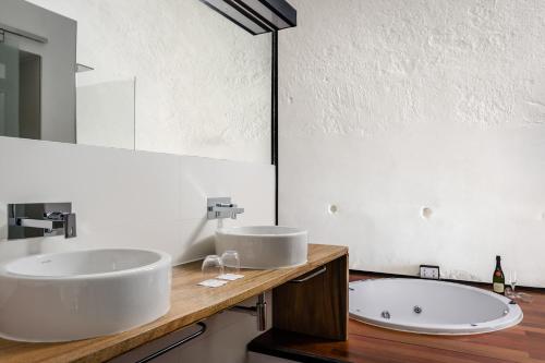 
a bathroom with a sink and a bathtub at Eurostars Fuerte de la Concepción in Aldea del Obispo
