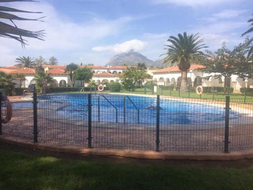 a swimming pool with a fence around it at Casas Blancas Bungalow 45 in L’Alfàs del Pi