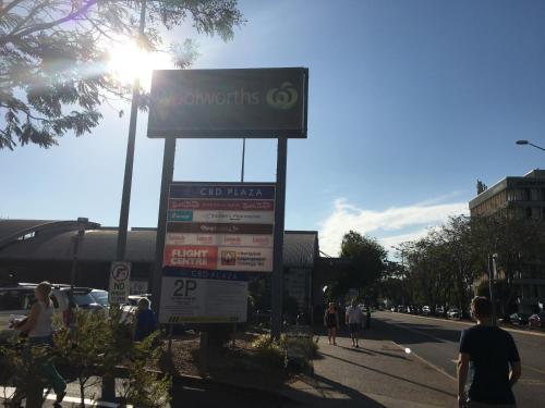 a sign for a gas station on a city street at Darwin City Harbour views-Situated above the OAK Restaurant in Darwin
