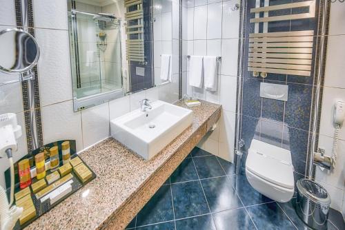 a bathroom with a sink and a toilet at Atakosk Group Hotels in Ankara
