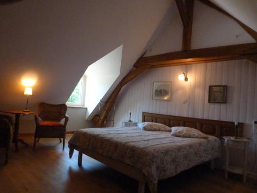 a bedroom with a large bed in a attic at Le Grand Gite De La Promenade in Montoire-sur-le-Loir