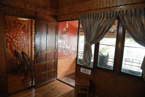 a room with a door and a window and a chair at Sajeev Home Stay in Cherai Beach