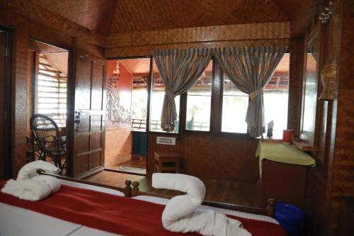 a room with a mirror and some white towels at Sajeev Home Stay in Cherai Beach