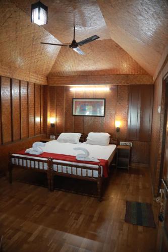 a bedroom with a large bed with a ceiling at Sajeev Home Stay in Cherai Beach
