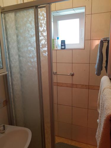 a bathroom with a shower and a sink at Mir in Sveti Ivan Žabno