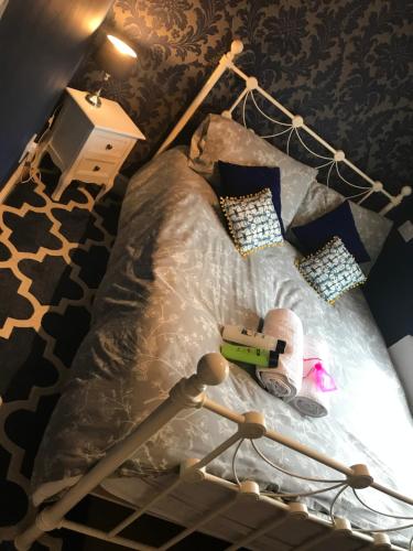 a bed with a black and white comforter and pillows at Central city 1 bed apartment in Bath