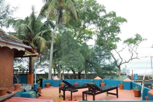 a group of benches sitting next to a blue fence at Sajeev Home Stay in Cherai Beach