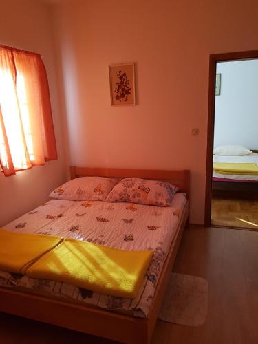 a bedroom with a bed and a window and a mirror at Mir in Sveti Ivan Žabno