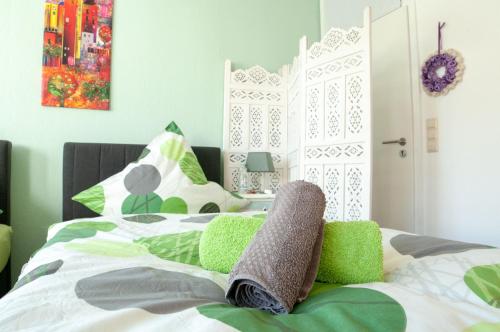 um quarto com uma cama verde e branca em FeWo Casa Mallorca em Coesfeld